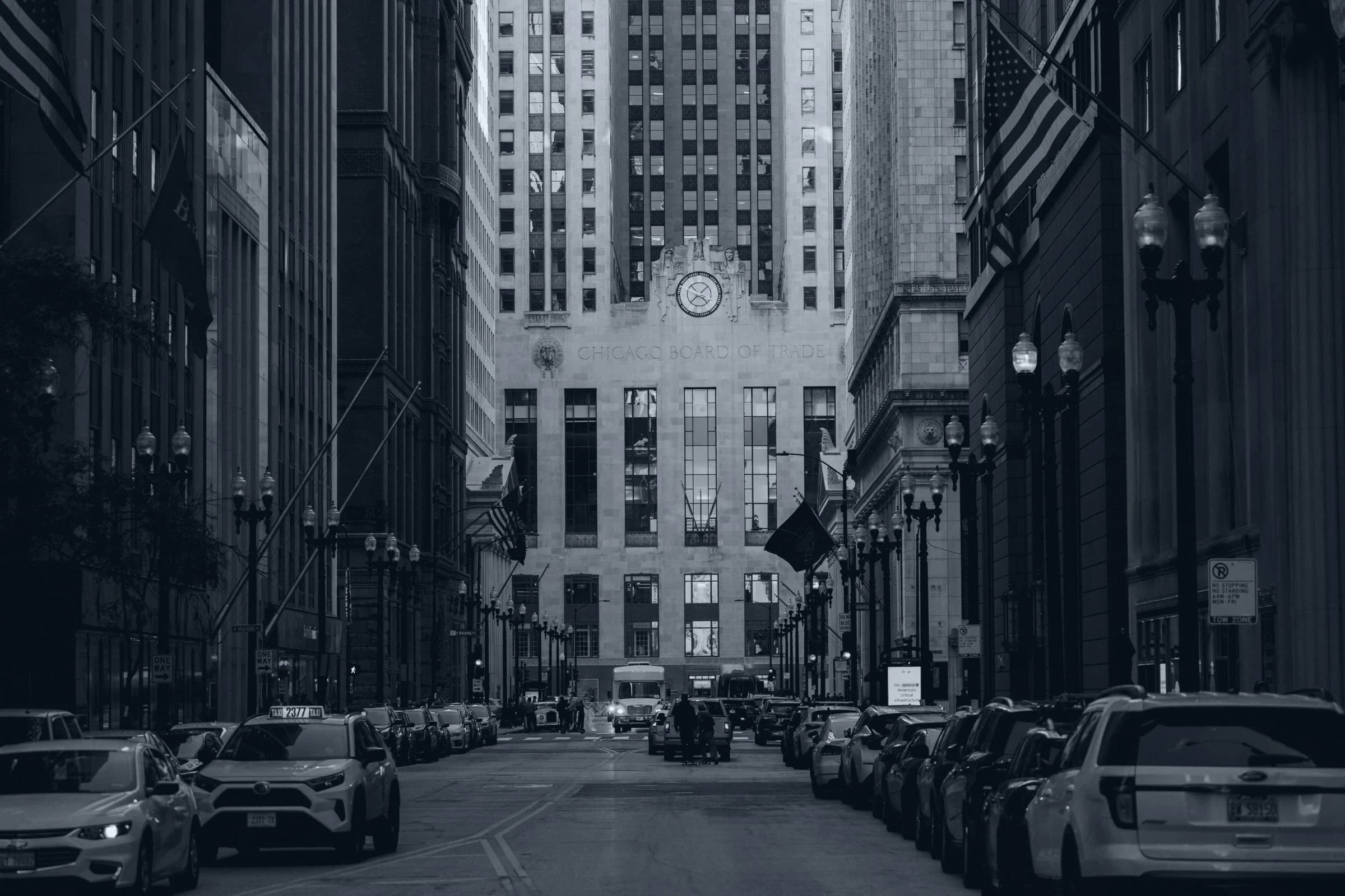 Black-and-white view along a Chicago street towards the Chicago Board of Trade building.
